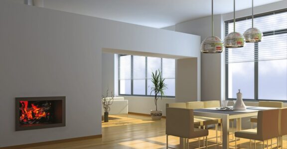 Salle à manger moderne : table blanche, chaises beiges, grandes fenêtres, plante en pot. Logo Vivacio en bas à gauche.